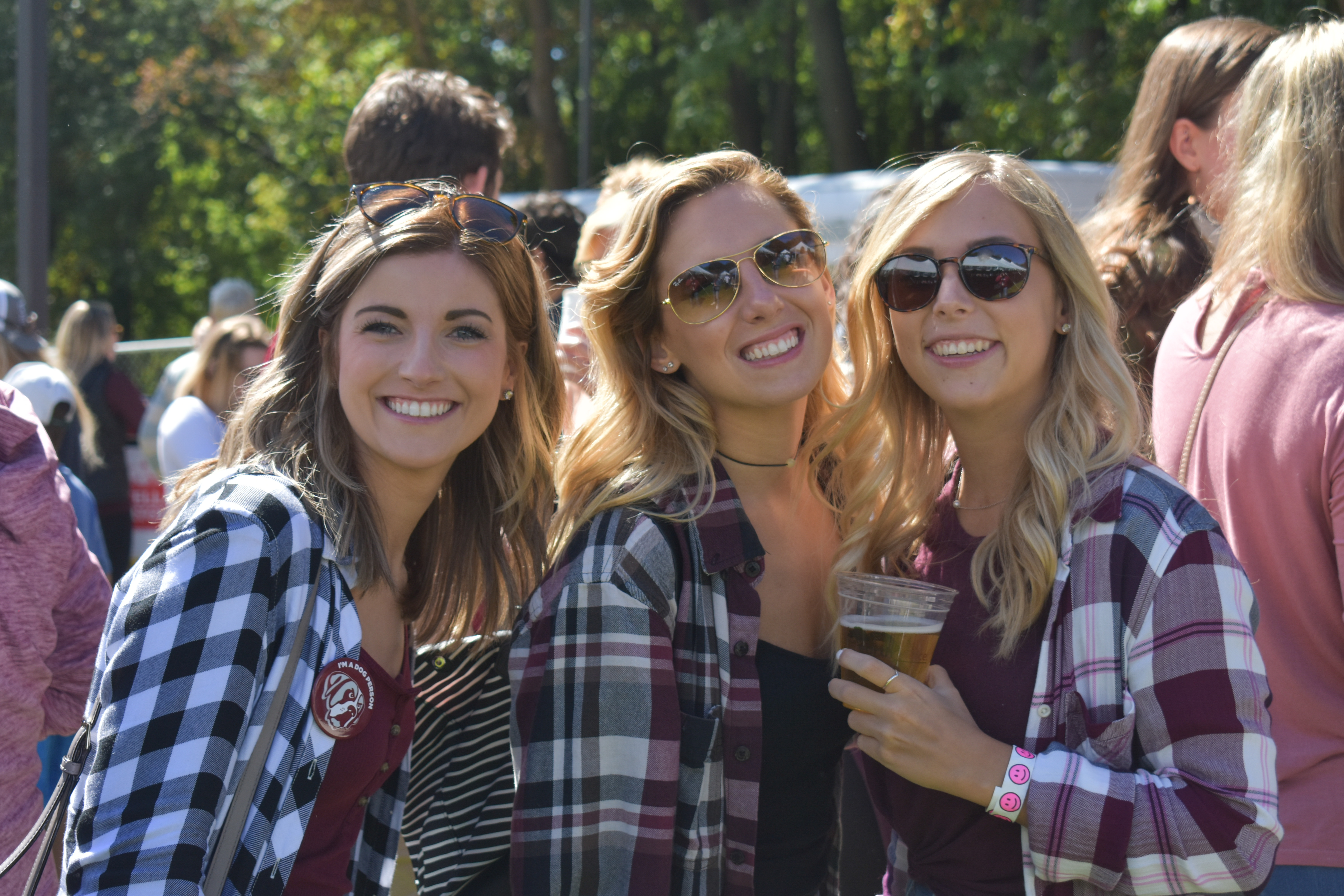 Friends gathered at homecoming in AQ gear. 