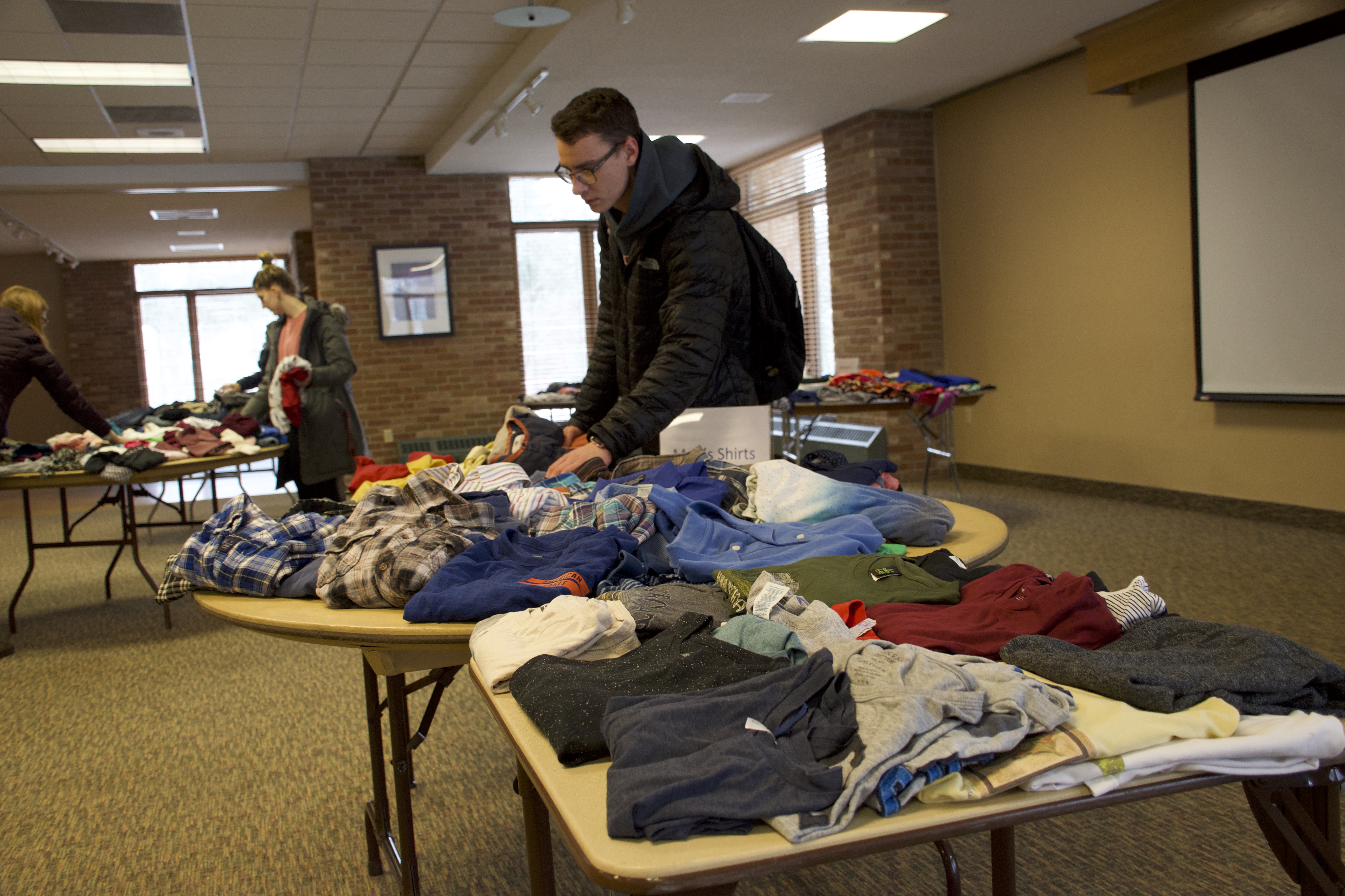 Students looking at clothing at SaintSwap