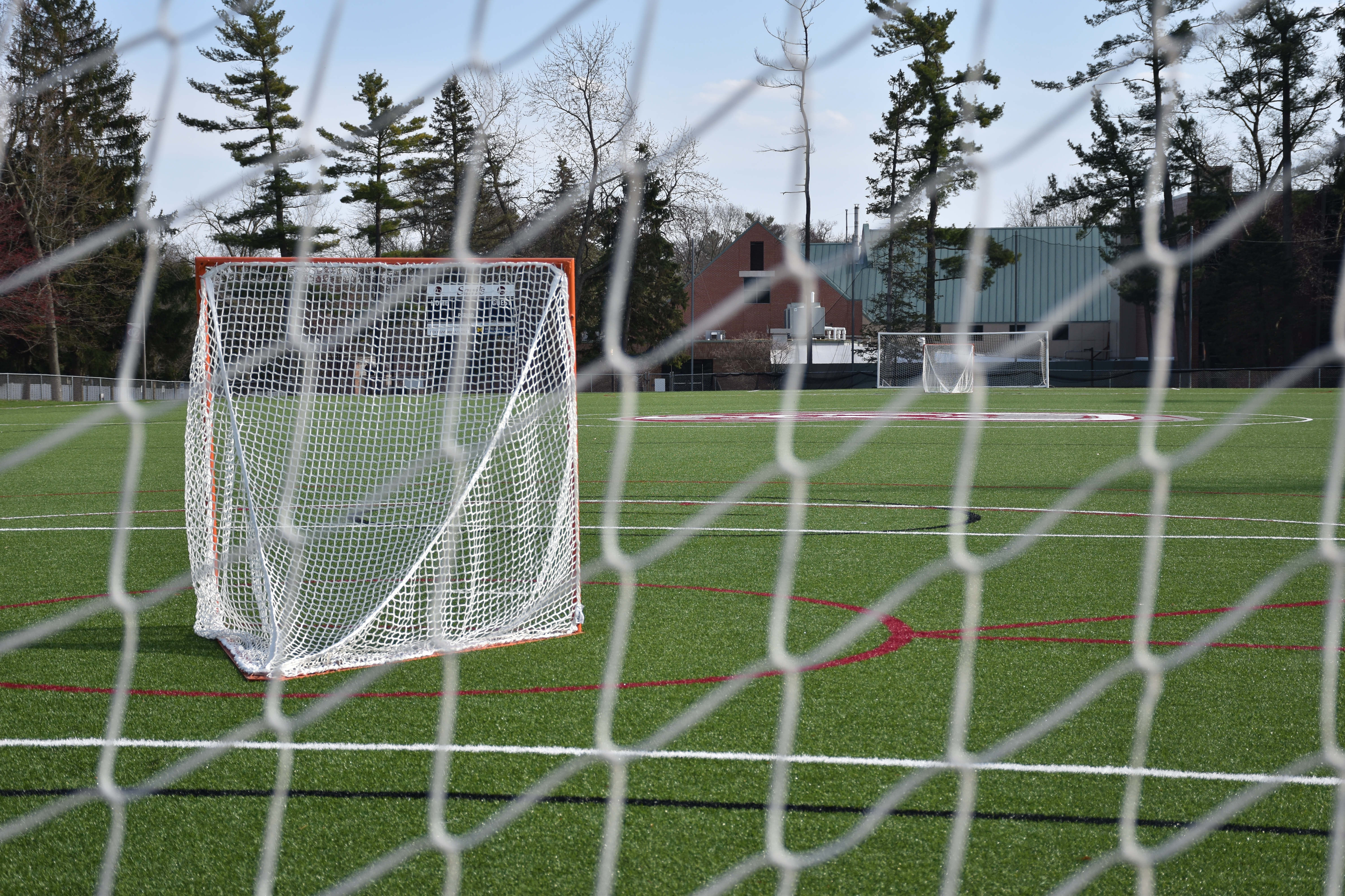 view of the empty athletic field from behind the goals